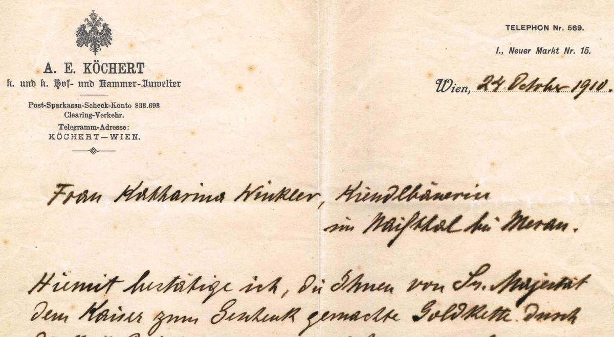 Ausschnitt eines vergilbten historischen Briefbogens mit gedrucktem Firmenkopf, Wappen und handschriftlichen Notizen.